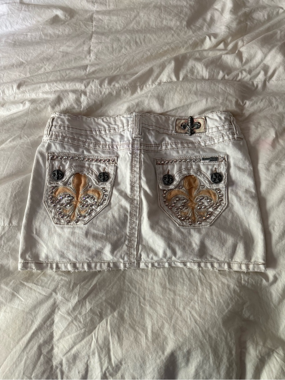 White Embellished Mini Skirt with Fleur-de-Lis Accent